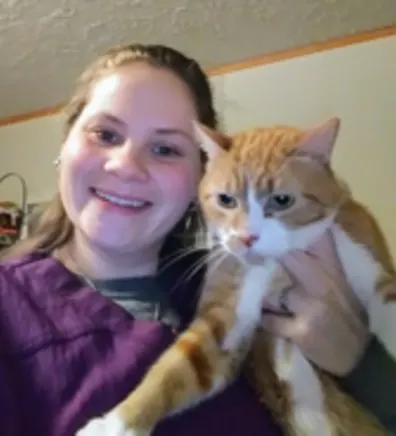 Alicia Harrington holding orange and white cat